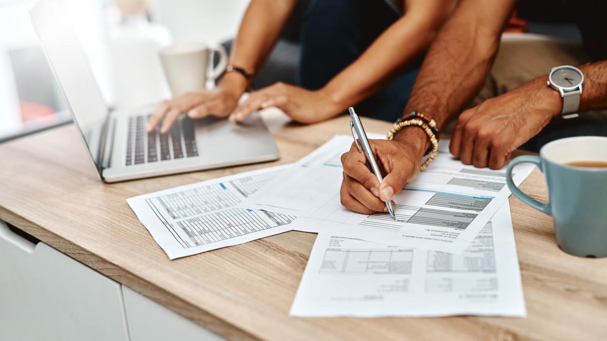 Cropped shot of a couple going over their finances together at home.