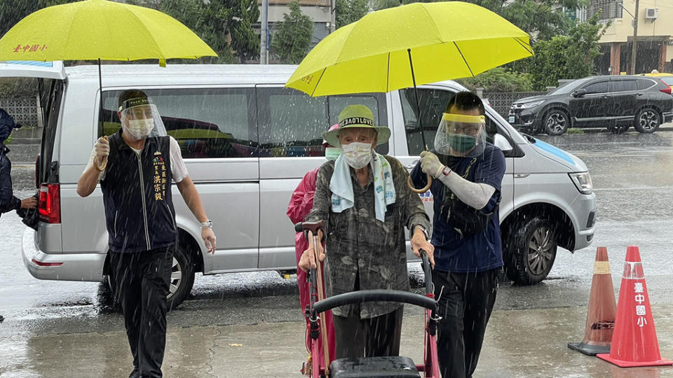 台中市東區快打站工作人員貼心為長者撐傘，減少降雨帶來的不便。