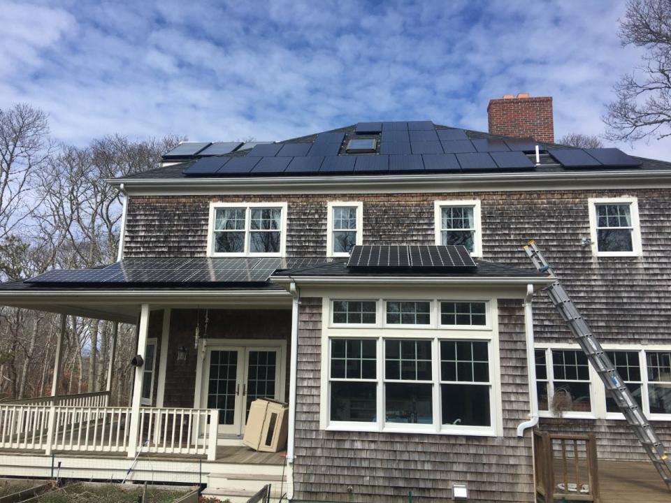 Dan Kilfoyle's Falmouth home has a rooftop mounted photovoltaic array (in the foreground) and solar hot water (left upper corner). The home is among the properties featured in the solar homes tour planned on the Cape on Saturday.