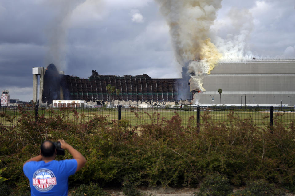 A historic blimp hangar burns in Tustin, Calif., Tuesday, Nov. 7, 2023. A fire destroyed a massive World War II-era wooden hangar that was built to house military blimps based in Southern California. (AP Photo/Jae C. Hong)