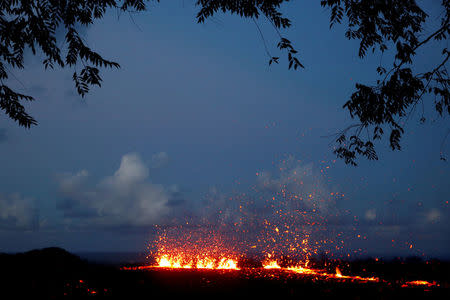 Lava erupts from a fissure on the outskirts of Pahoa during ongoing eruptions of the Kilauea Volcano in Hawaii, U.S., May 14, 2018. REUTERS/Terray Sylvester