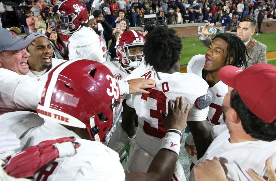 Nov 25, 2023; Auburn, Alabama, USA; Alabama Crimson Tide defensive back Terrion Arnold (3) and Alabama Crimson Tide wide receiver Isaiah Bond (17) celebrate a game-ending interception to give the Alabama Crimson Tide the victory over the Auburn Tigers at Jordan-Hare Stadium. Alabama defeated Auburn 27-24. Mandatory Credit: Gary Cosby Jr.-USA TODAY Sports