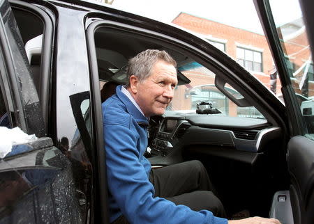 Republican presidential candidate and Ohio Governor John Kasich gets in his car as he leaves the Red Arrow Diner after a campaign stop in Manchester, New Hampshire February 9, 2016. REUTERS/Mary Schwalm