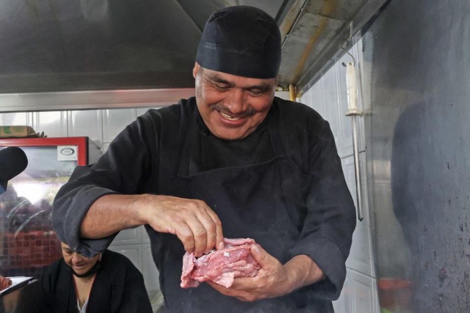 Newly minted Michelin-starred chef Arturo Rivera Martínez prepares a customer at Tacos El Califa de León in Mexico City on May 15, 2024. AFP via Getty Images