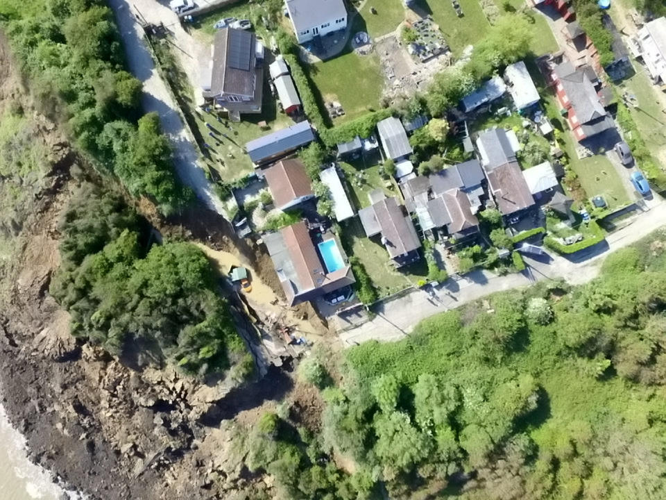 Residents were left without electricity and one person's house was in danger of falling down the cliff. (Picture: SWNS)