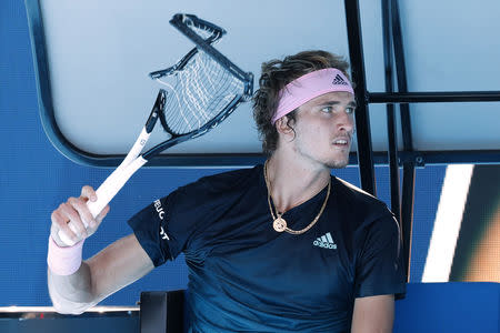 Tennis - Australian Open - Fourth Round - Melbourne Park, Melbourne, Australia, January 21, 2019. Germany's Alexander Zverev holds his smashed racket during his match against Canada’s Milos Raonic. REUTERS/Kim Kyung-Hoon