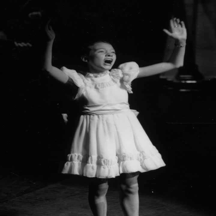 julie as a child singing on stage
