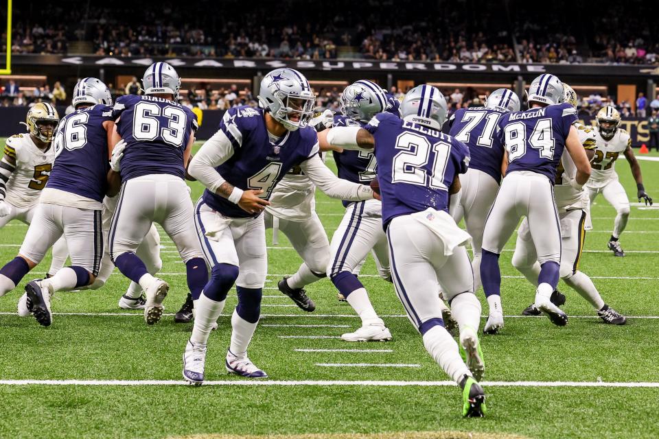 Dallas Cowboys quarterback Dak Prescott (4) hands the ball off to running back Ezekiel Elliott (21) during last week's win over the New Orleans Saints.