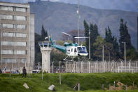 A helicopter carrying former rebel leader Seuxis Hernandez takes off from La Picota jail in Bogota, Colombia, Friday, May 17, 2019. The former peace negotiator, best known by his alias Jesús Santrich, was re-arrested immediately after his release that was orderer by a special tribunal investigating war crimes during Colombia's civil conflict that ruled Wednesday that he should not be extradited to the United States. (AP Photo/Fernando Vergara)