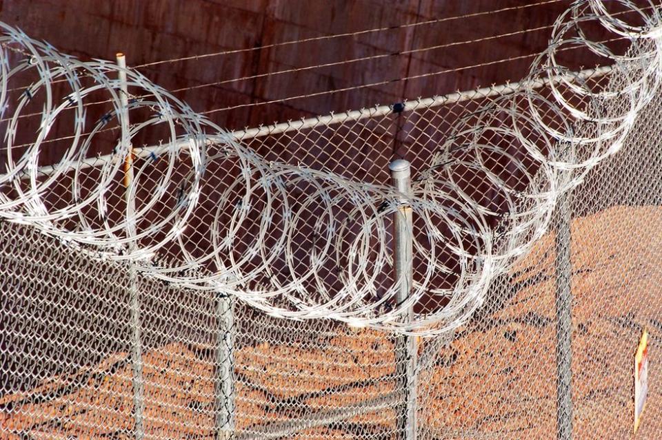 horrific reality transgender people Texas prison system Chain link fence razor wire