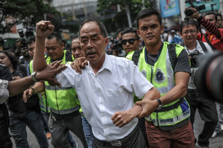 A demonstrator is detained during a protest against Malaysian Prime Minister Najib Razak in Kuala Lumpur on August 1, 2015