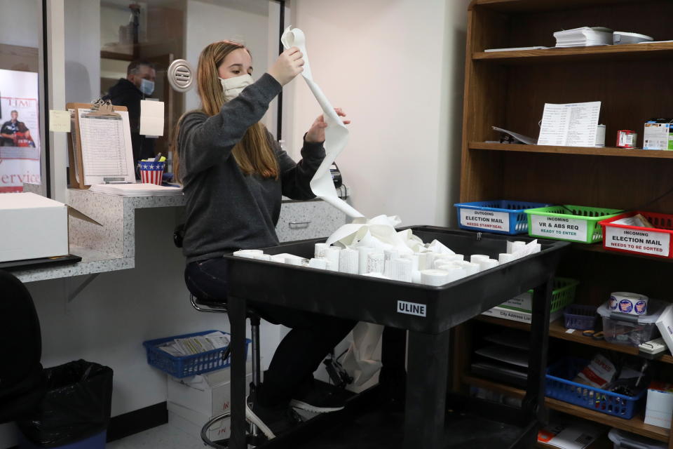 Alyssa Padjen, a City Clerk intern, organizes tapes from ballot counting machines after Election Day at the Kenosha Municipal Building in Kenosha, Wisconsin, U.S. November 4, 2020. REUTERS/Daniel Acker