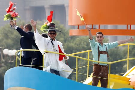 Foreign citizens take part in a parade through Tiananmen Square marking the 70th founding anniversary of People's Republic of China, on its National Day in Beijing