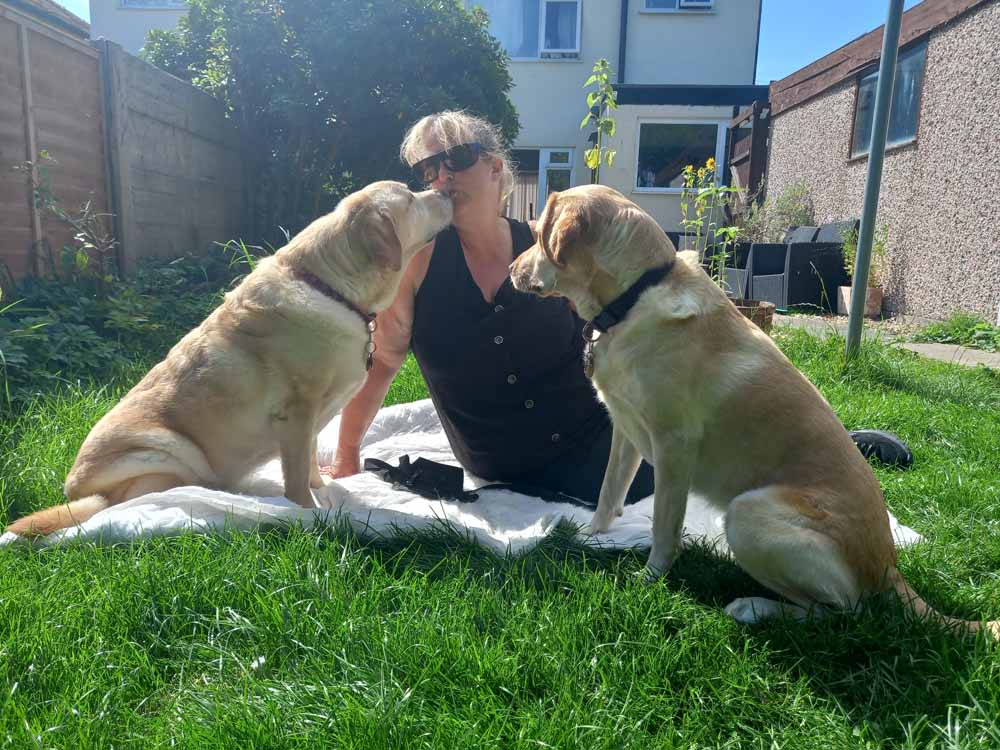 Nicky at home with guide dogs Tillie and Unity (PA Real Life/Collect)