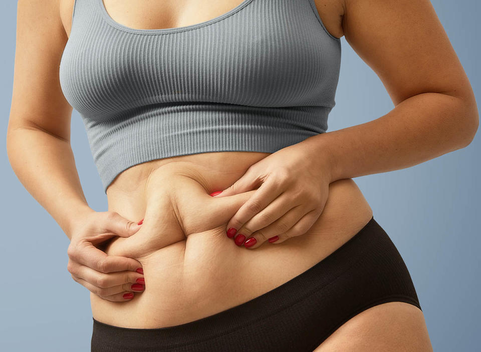 woman holding belly fat