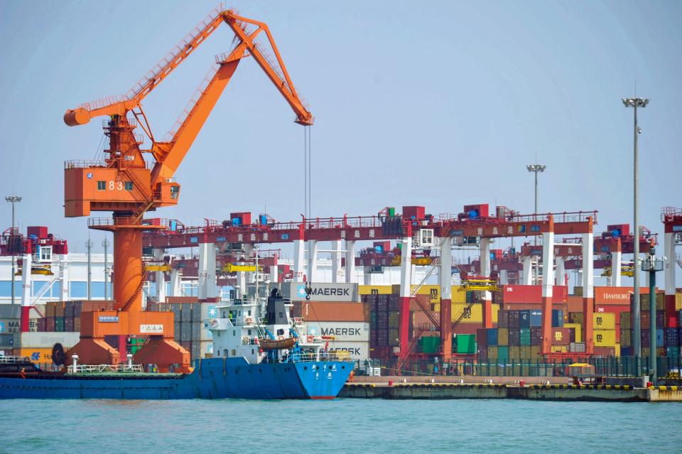 A crane transfers goods at a port in Qingdao, in China's eastern Shandong province on June 10, 2019. - China's exports beat gloomy forecasts to rebound in May though imports sank more than expected as the trade war with the United States heats up, official data showed on May 10. (Photo by STR / AFP) / China OUT        (Photo credit should read STR/AFP/Getty Images)