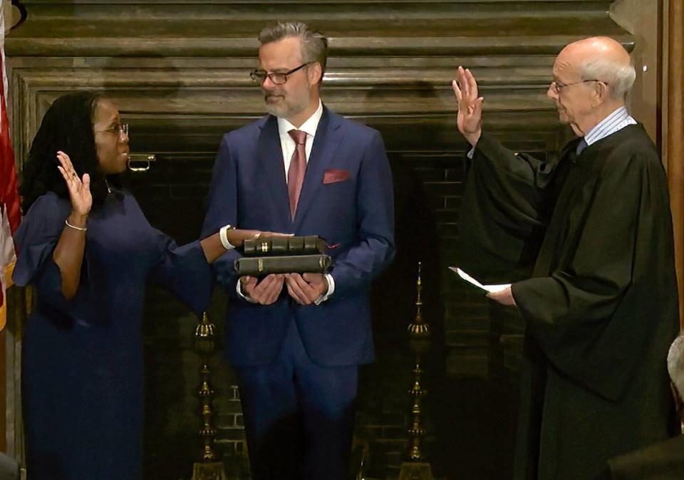 In this image from video provided by the Supreme Court, retired Supreme Court Associate Justice Stephen Breyer administers the Judicial Oath to Ketanji Brown Jackson as her husband, Patrick Jackson, holds the Bible at the Supreme Court in Washington on Thursday, June 30, 2022.