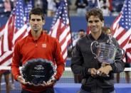 Rafael Nadal of Spain poses with his trophy after defeating Novak Djokovic of Serbia (L, with runner up trophy) in their men's final match at the U.S. Open tennis championships in New York, September 9, 2013. REUTERS/Mike Segar