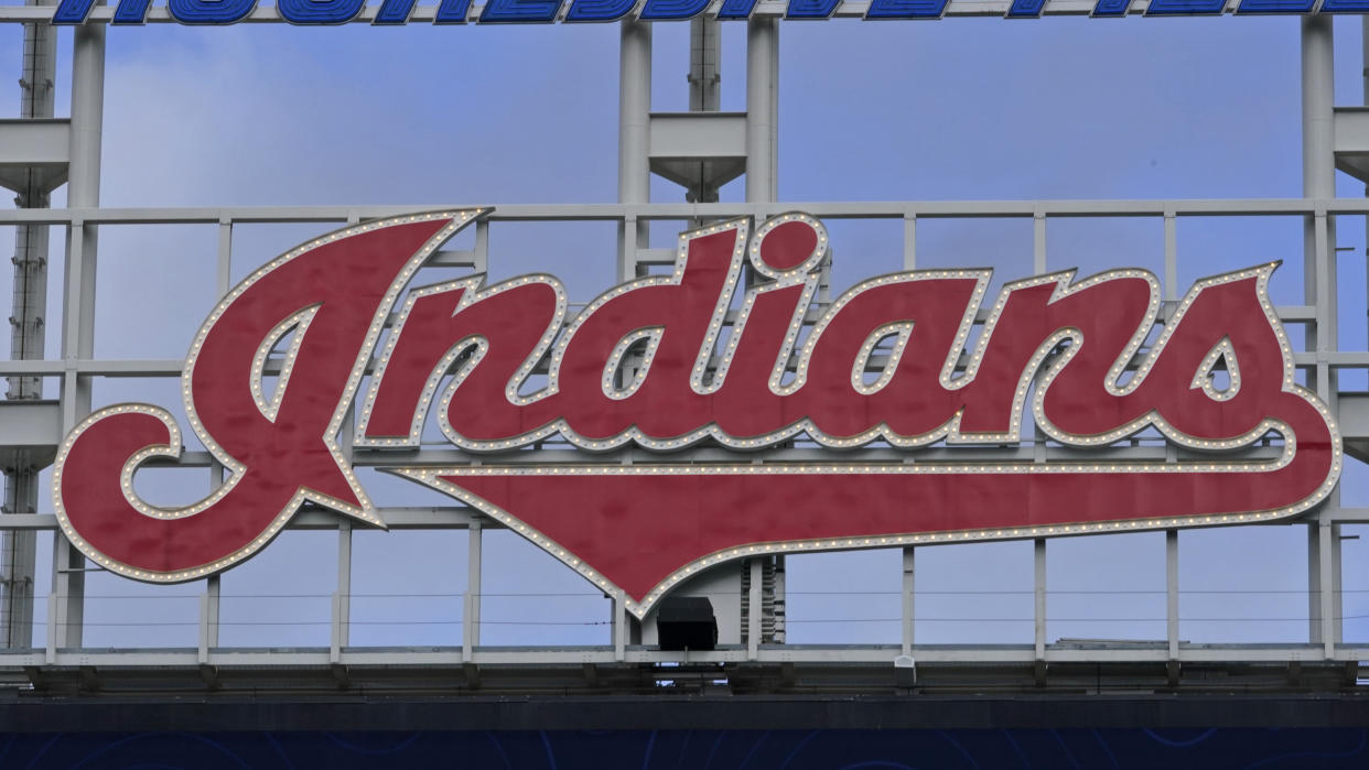 FILE - The Indians sign hangs at Progressive Field before the first baseball game of a doubleheader against the Chicago White Sox, Thursday, Sept. 23, 2021, in Cleveland. The Indians began removing the team's scripted logo atop the giant scoreboard at Progressive Field on Tuesday, Nov. 2, 2021, as they transition their name to Guardians. (AP Photo/Tony Dejak, File)