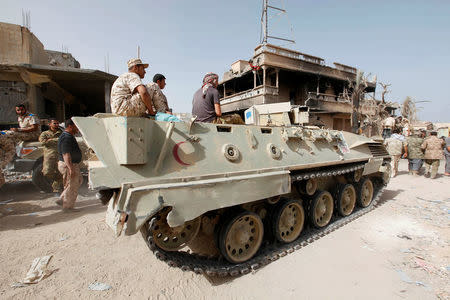 Fighters of Libyan forces allied with the U.N.-backed government sit atop a military vehicle near the front line of fighting with Islamic State militants in Ghiza Bahriya district in Sirte, Libya November 9, 2016. REUTERS/Ismail Zitouny