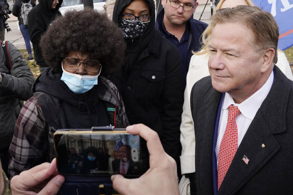 Mark McCloskey, right, a Republican candidate for U.S. Senate in Missouri, listens to a protester outside the Kenosha County Courthouse, Tuesday, Nov. 16, 2021 in Kenosha, Wis., during the Kyle Rittenhouse murder trial. Rittenhouse is accused of killing two people and wounding a third during a protest over police brutality in Kenosha, last year. (AP Photo/Nam Y. Huh)