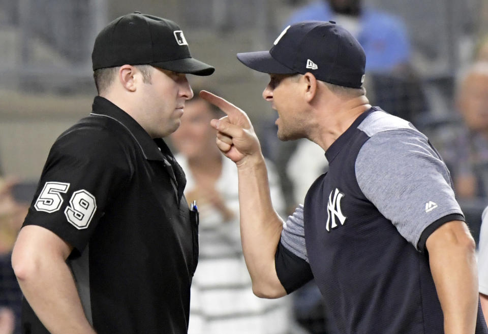 New York Yankees manager Aaron Boone, right, confronts umpire Nic Lentz before being tossed from a baseball game against the Detroit Tigers during the fifth inning Friday. (AP Photo)