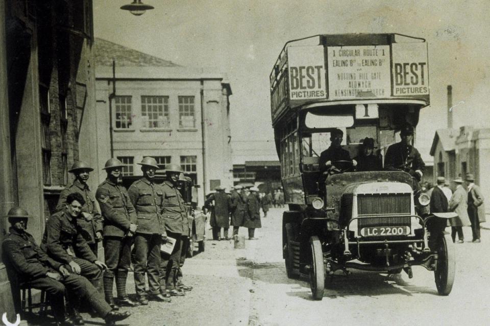 circa 1926: The No.1 bus, which did a circular route starting and ending at Ealing Broadway and calling at Notting Hill Gate, Aldwych and Kensington, while soldiers line the streets. (SSPL/Getty Images)