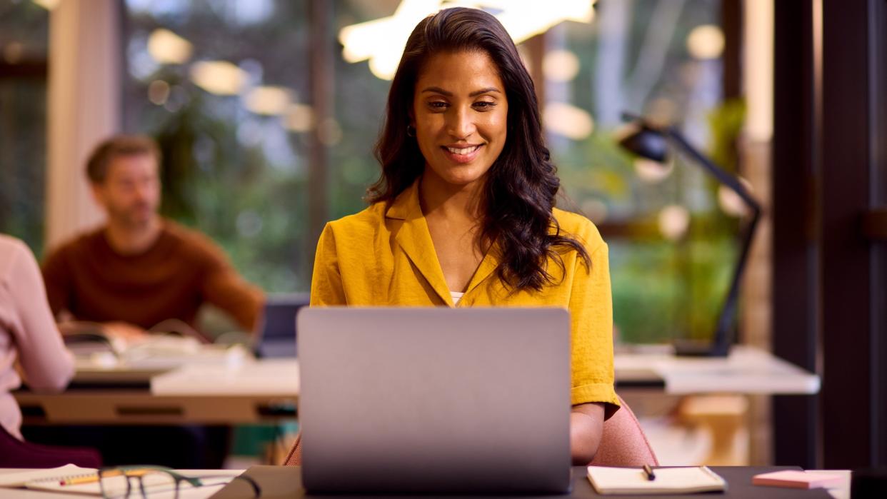  Person using a Windows laptop and looking happy. 