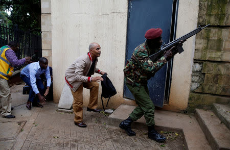 FILE PHOTO: A member of security forces keeps guard as people are evacuated at the scene where explosions and gunshots were heard at the Dusit hotel compound, in Nairobi, Kenya January 15, 2019. REUTERS/Thomas Mukoya/File Photo