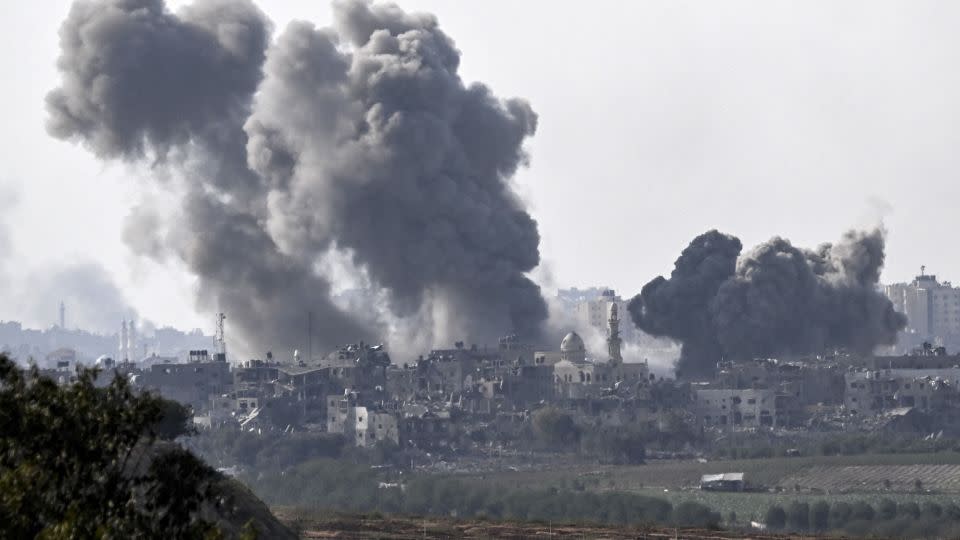 A picture taken from Sderot shows smoke plumes rising above buildings during an Israeli strike on the northern Gaza Strip on Saturday - Aris Messinis/AFP/Getty Images