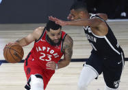 Toronto Raptors guard Fred VanVleet, left, drives against Brooklyn Nets guard Timothe Luwawu-Cabarrot, right, during the first half of Game 4 of an NBA basketball first-round playoff series, Sunday, Aug. 23, 2020, in Lake Buena Vista, Fla. (Kim Klement/Pool Photo via AP)