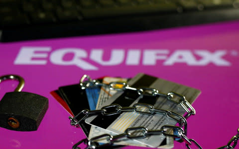 Credit cards, a chain and an open padlock is seen in front of displayed Equifax logo - Credit: Dado Ruvic/Reuters