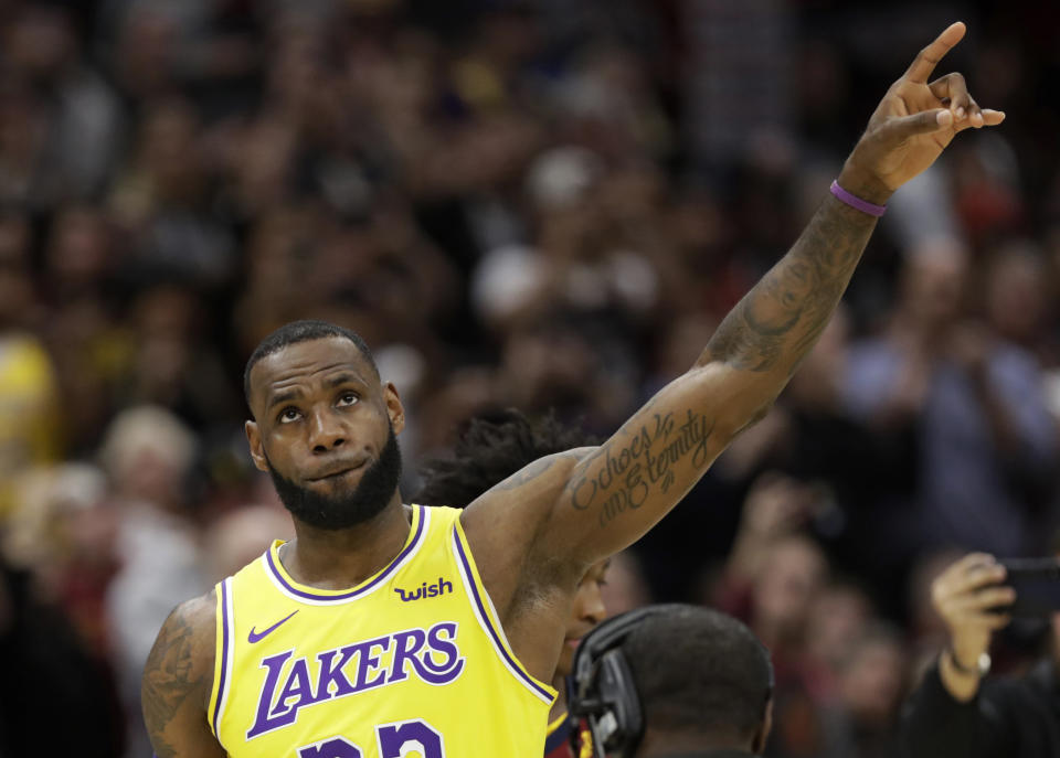 Los Angeles Lakers' LeBron James acknowledges the Cleveland fans during a video tribute to James during the first half of an NBA basketball game between the Lakers and the Cleveland Cavaliers, Wednesday, Nov. 21, 2018, in Cleveland. (AP Photo/Tony Dejak)