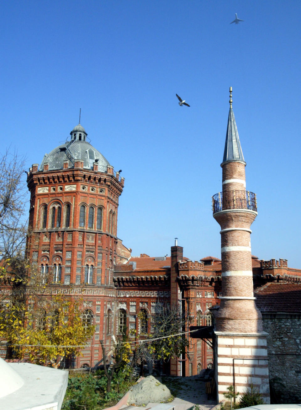 FILE - This Nov. 22, 2006 file photo shows Historical Greek Orthodox high school, left, next to a mosque in Istanbul's Fener neighborhood. Istanbul has a number of interesting neighborhoods worth exploring, with attractions ranging from well-known landmarks like this to small shops, galleries and cafes. (AP Photo/Osman Orsal, File)