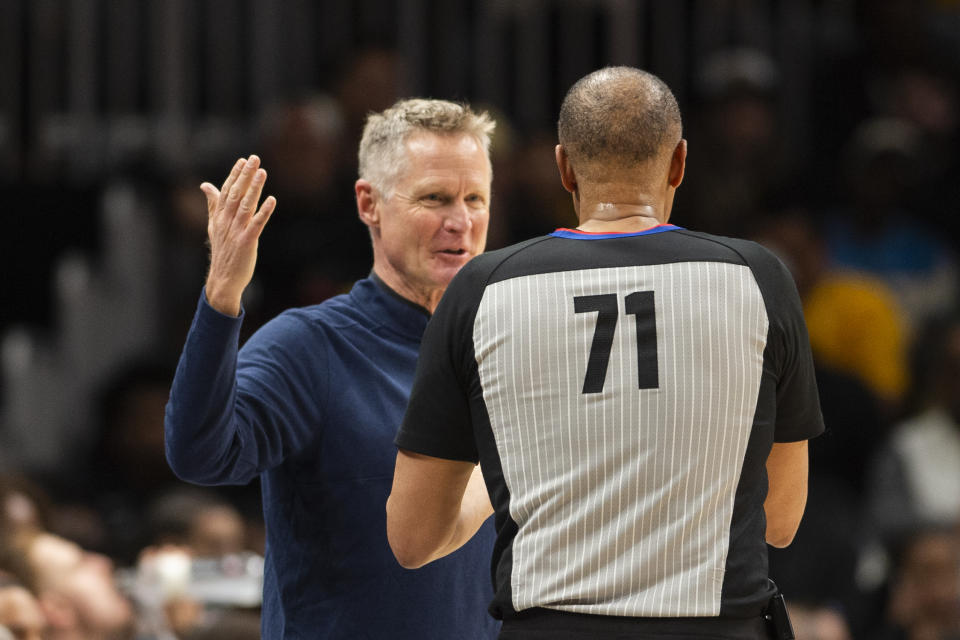 Golden State Warriors head coach Steve Kerr, left, speaks with referee Rodney Mott during the second half of an NBA basketball game against the Atlanta Hawks, Friday, March 17, 2023, in Atlanta. (AP Photo/Hakim Wright Sr.)