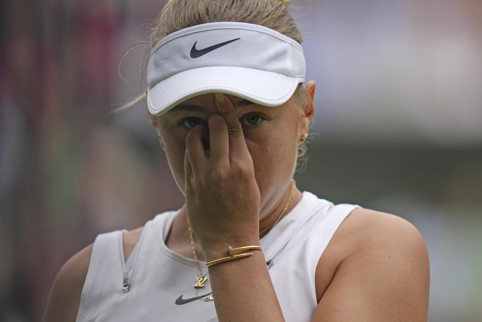 Amanda Anisimova of the US reacts as she plays Romania's Simona Halep in a women's singles quarterfinal match on day ten of the Wimbledon tennis championships in London, Wednesday, July 6, 2022. (AP Photo/Alastair Grant)