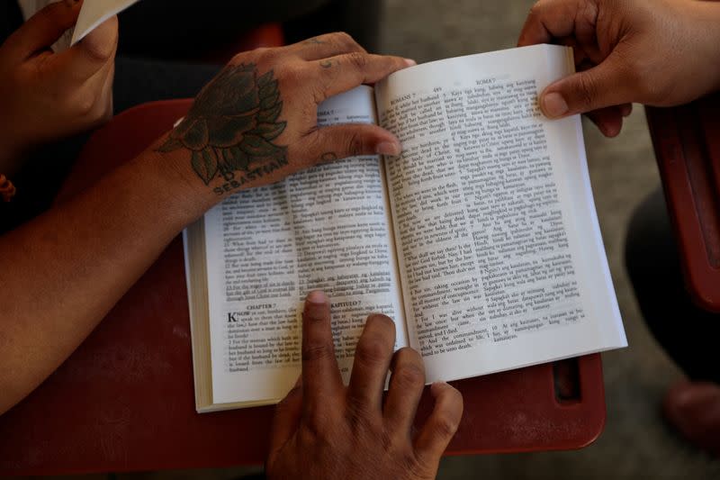 A recovered drug addict reads the Bible before being released from the Mega Drug Abuse Treatment and Rehabilitation Center, in Nueva Ecija province