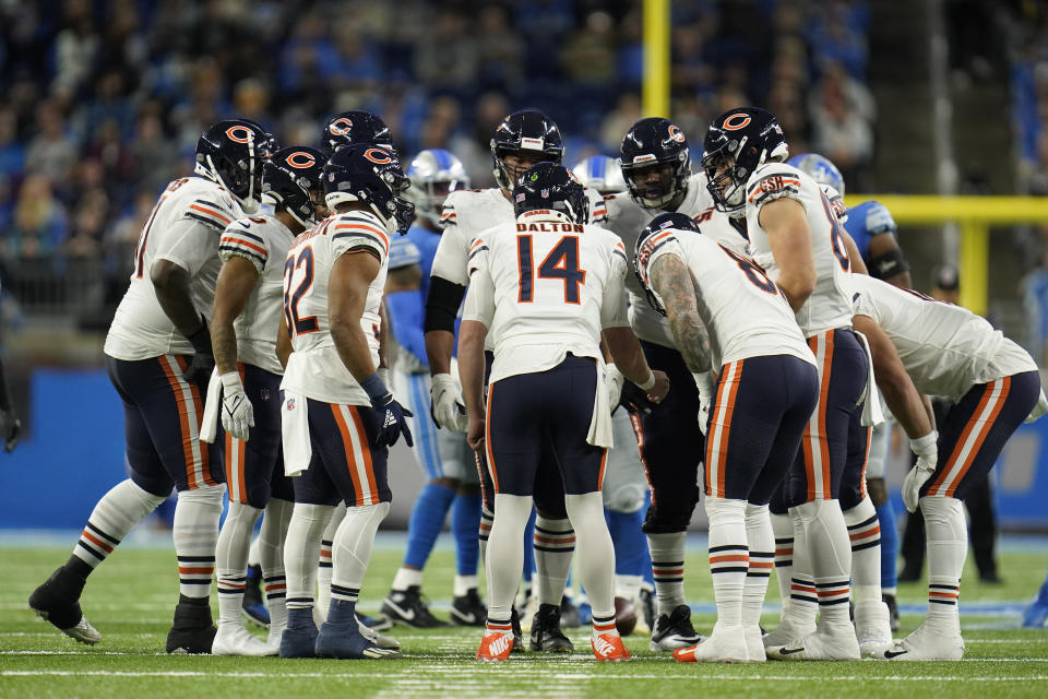 Chicago Bears quarterback Andy Dalton (14) huddles with the team during the first half of an NFL football game against the Detroit Lions, Thursday, Nov. 25, 2021, in Detroit. (AP Photo/Paul Sancya)