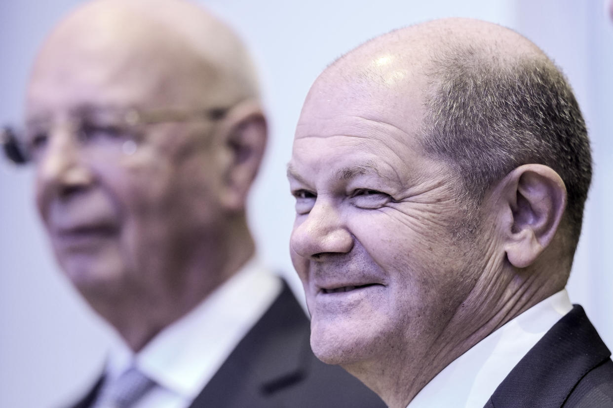 German Chancellor Olaf Scholz, right, arrives with World Economic Forum founder Klaus Schwab for a speech at the World Economic Forum in Davos, Switzerland, on Wednesday, Jan. 18, 2023. The annual meeting of the World Economic Forum is taking place in Davos from Jan. 16 until Jan. 20, 2023. (AP Photo/Markus Schreiber)