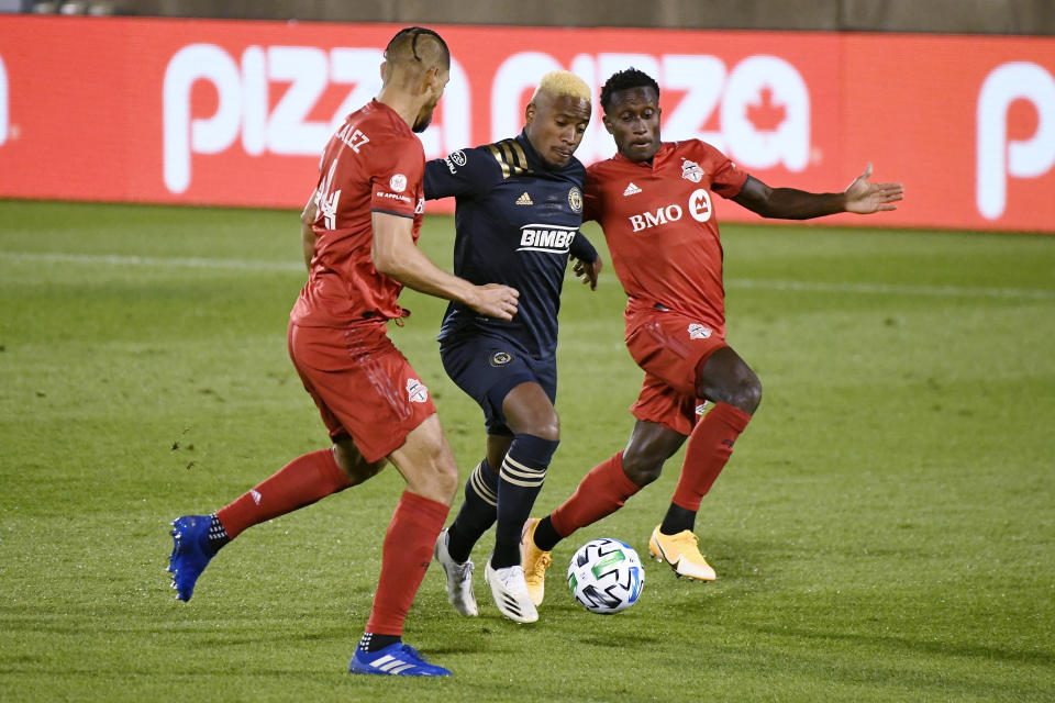 Philadelphia Union's Sergio Santos, center, cuts between Toronto FC's Omar Gonzalez, left, and Richie Laryea to score a goal during the first half of an MLS soccer match Saturday, Oct. 3, 2020, in East Hartford, Conn. (AP Photo/Jessica Hill)