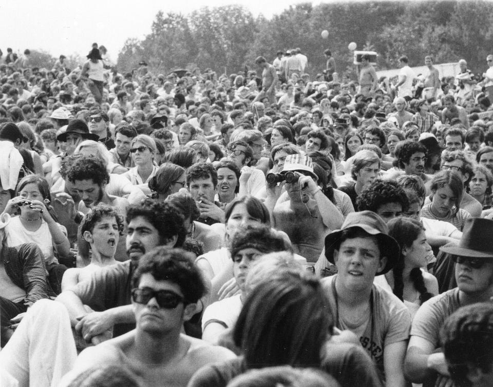 FILE - In this Aug. 15, 1969 file photo, concert goers attend the Woodstock Music and Arts Festival held on a 600-acre pasture in the Catskill Mountains near White Lake in Bethel, N.Y. The famous concert poster with a bird perched on a guitar neck advertised “three days of peace and music,” spanning from Aug. 15-17. But Woodstock lasted more than three days. Thanks to delays, it bled into the morning of Aug. 18. (AP Photo/File)