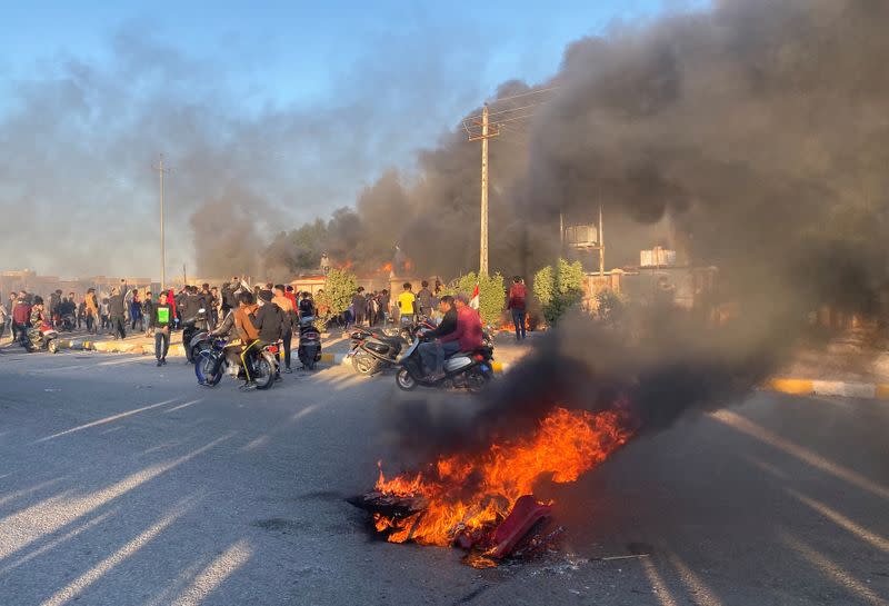 A headquarters building of Popular Mobilization Forces (Hashd al-Shaabi) burns after being torched by demonstrators during ongoing anti-government protests, in Nassiriya