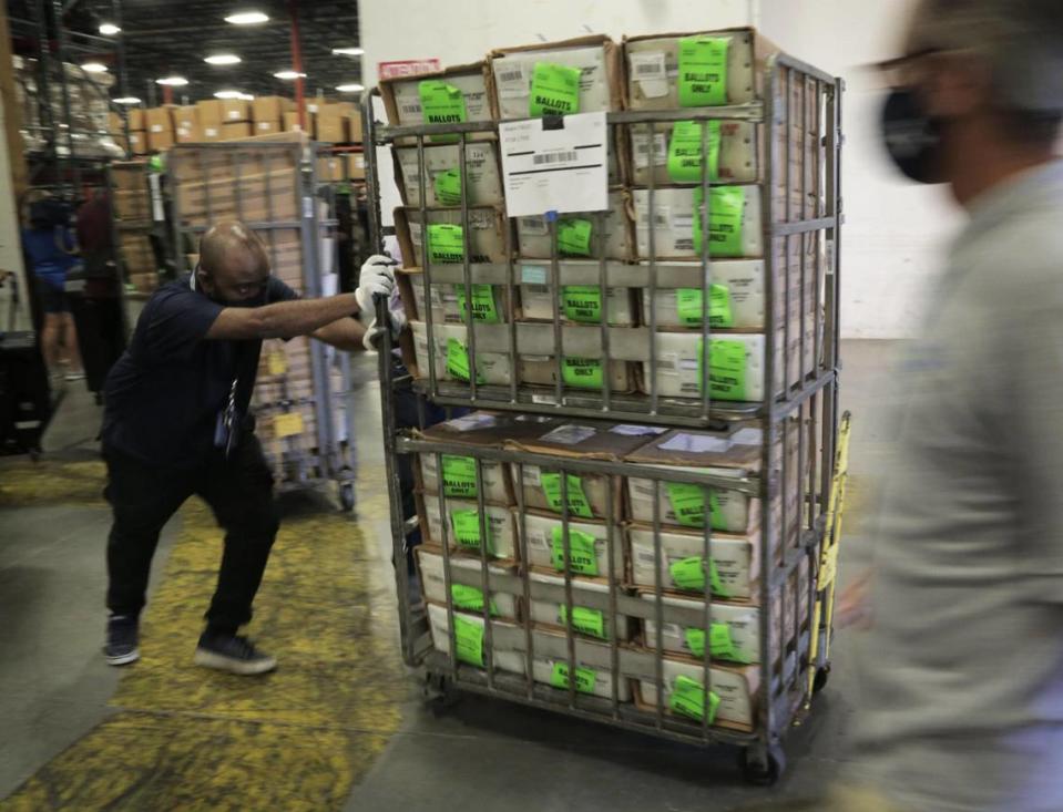 Workers load carts filled with ballots onto a waiting USPS truck at the Miami-Dade Elections Department in Doral, Florida, on Oct. 1, 2020. The Miami-Dade County Elections Department mailed more than 530,000 vote-by-mail ballots on Oct. 1 to voters with a request on file for the Nov. 3, 2020, general election.