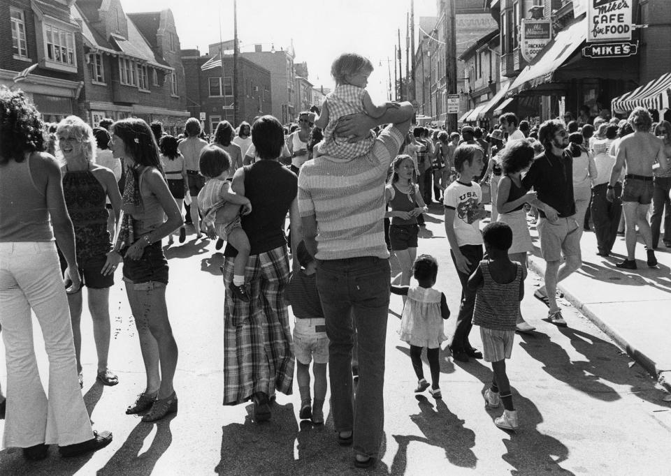 A family make their way through the Brady Street Festival crowds in this photo from the 1970s.
(Credit: Milwaukee Public Library)
