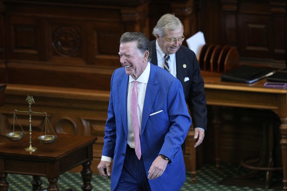 Defense attorney Dan Cogdell, front, and prosecution attorney Dick DeGuerin, rear, share a laugh during day four of the impeachment trial for Texas Attorney General Ken Paxton in the Senate Chamber at the Texas Capitol, Friday, Sept. 8, 2023, in Austin, Texas. (AP Photo/Eric Gay)