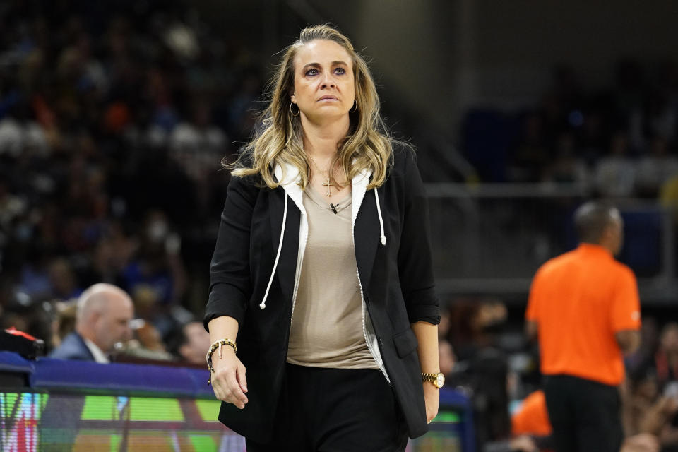 Team Wilson coach Becky Hammon looks at the scoreboard during the first half of the WNBA All-Star basketball game against Team Stewart in Chicago, July 10, 2022. Recent allegations by WNBA player Dearica Hamby that Hammon harassed her for being pregnant have shined a renewed spotlight on one of the biggest challenges that female professional athletes face. Las Vegas Aces coach Hammon, one of the league's marquee figures and a six-time WNBA All-Star, denied bullying Hamby; she said the player wasn't traded to the Los Angeles Sparks because she was pregnant. (AP Photo/Nam Y. Huh)