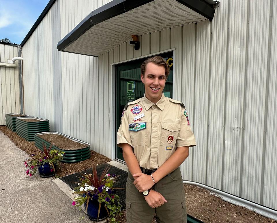 Isaac Brashaw, Eagle Scout, in front of the raised beds he built outside the Sheboygan County Food Bank.