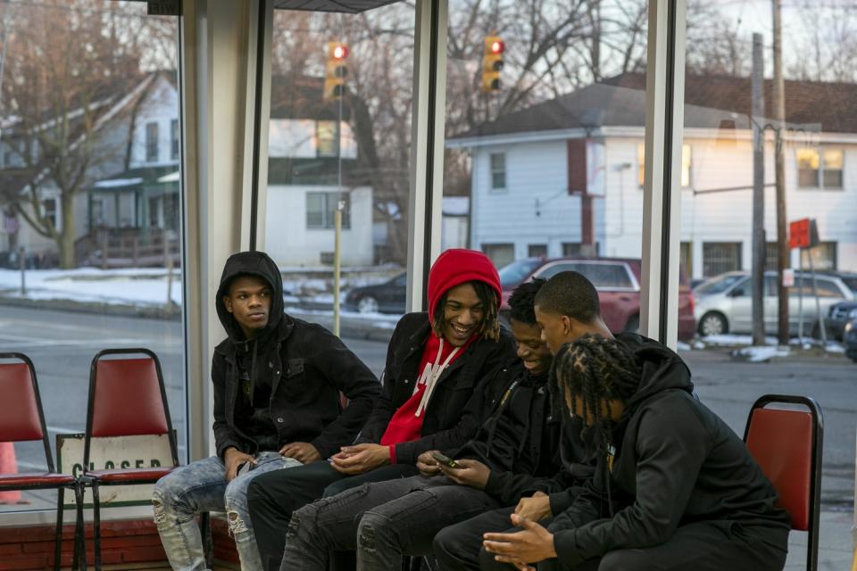 Flint teammates gather at Courtside Cuts the day before the big game against Beecher.