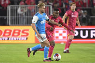 Charlotte FC forward Karol Swiderski, left, and St. Louis City SC midfielder Njabulo Blom (6) battle for control of the ball during the first half of an MLS soccer match Saturday, March 4, 2023, in St. Louis. (AP Photo/Joe Puetz)