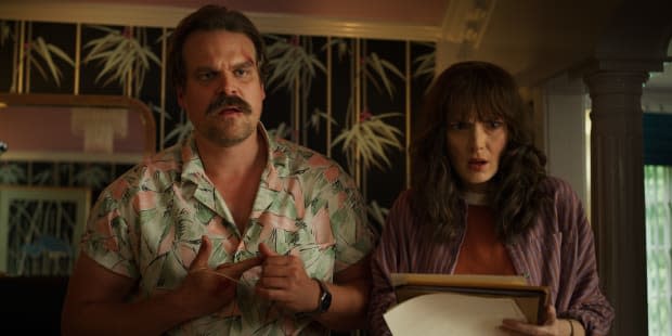 Hopper (David Harbour) in his Tom Selleck-inspired shirt and Joyce (Winona Ryder). Photo: Courtesy of Netflix